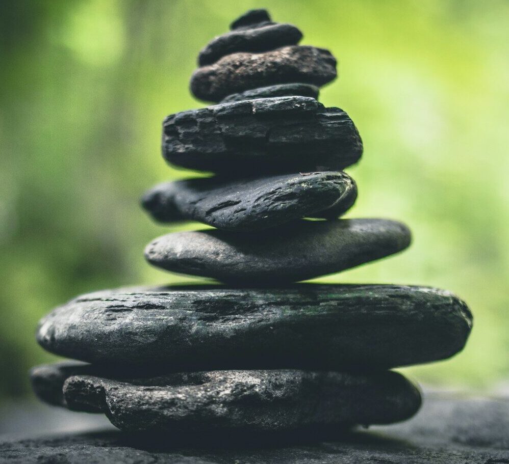 black stacking stones on gray surface